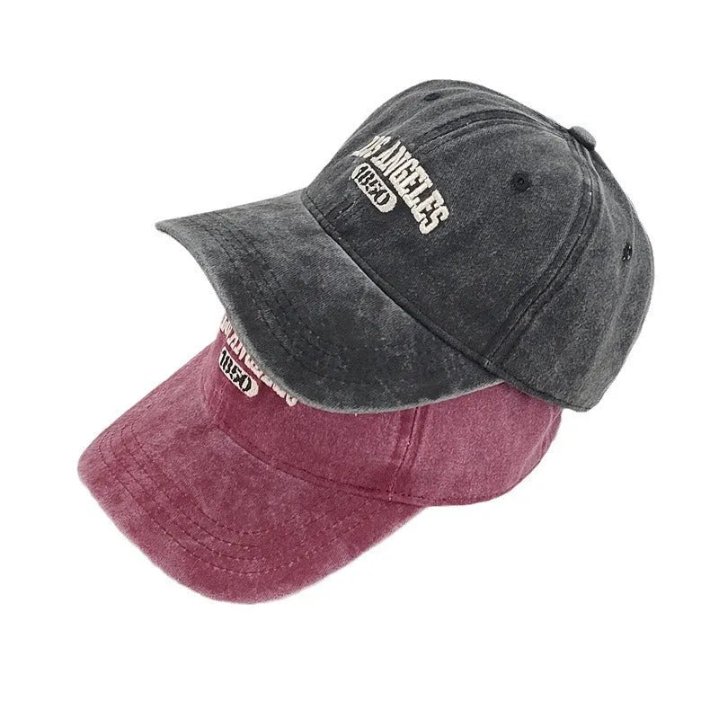 Retro washed distressed peaked cap with adjustable strap on back, shown in beige colour with a conical crown.