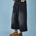 Men's loose straight-leg denim shorts in a light blue wash, showing fifth-pant length and relaxed fit.