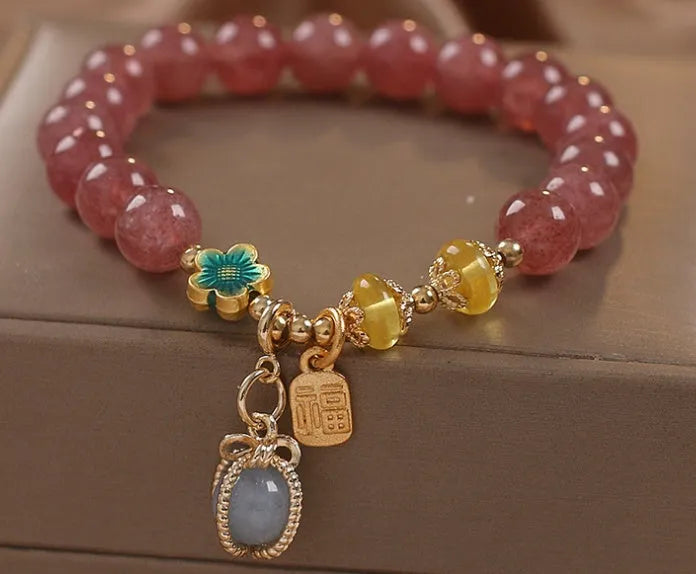Red women's beaded bracelet with a strawberry quartz centre stone and sparkling rhinestones on an alloy chain.