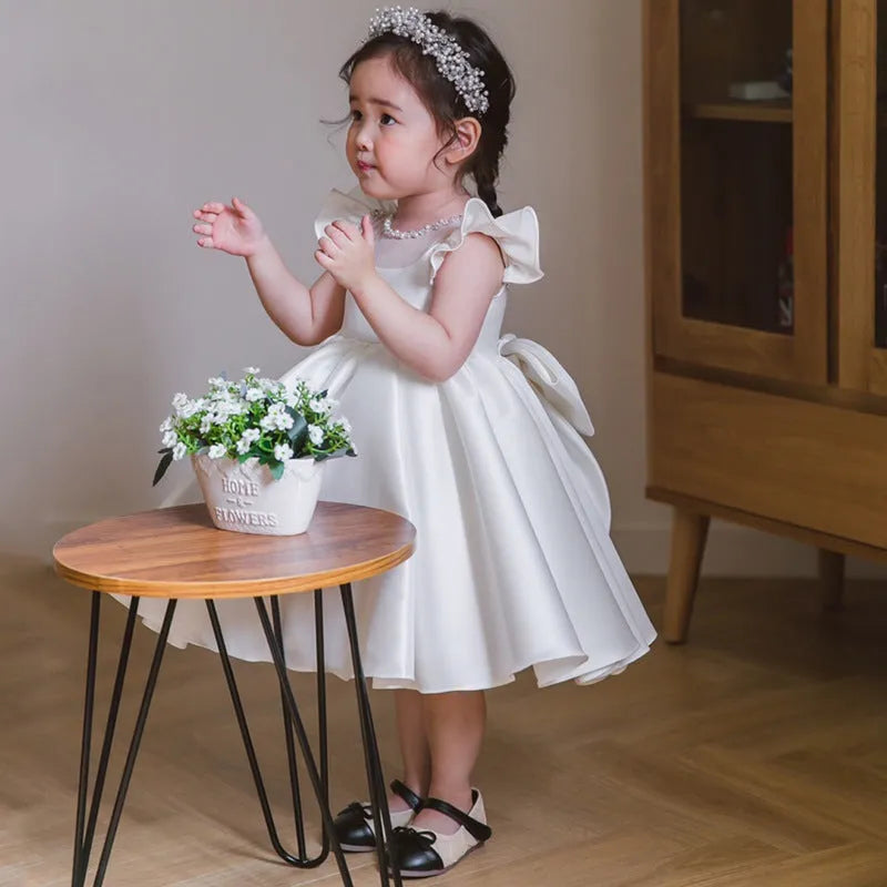 White satin princess dress for girls with puff sleeves, chemical fibre fabric, and flax lining on a white background