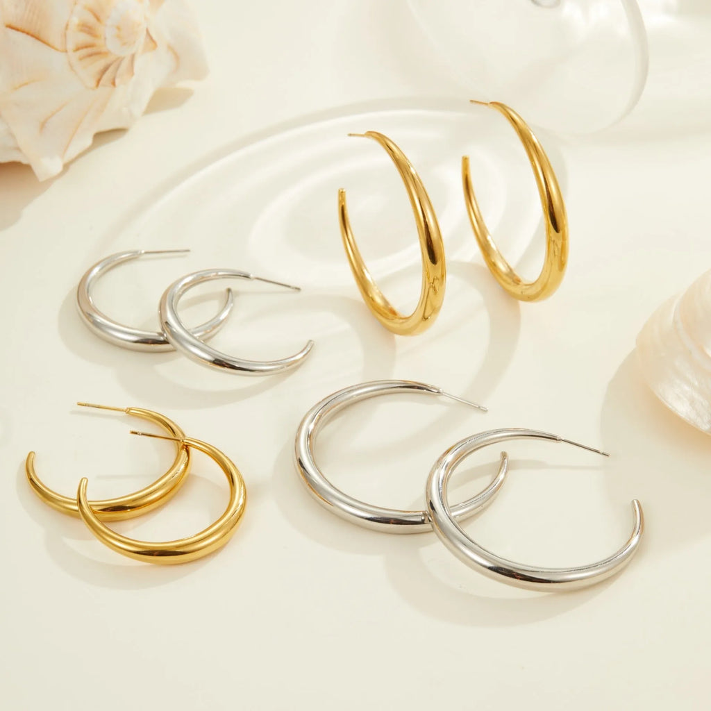 Geometric titanium steel hoop earrings for women in gold and steel finishes with round design elements