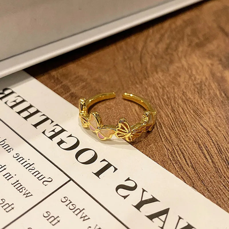 Simple copper women's ring with a Chinese butterfly design, showing an example from the 33 available numbered styles.