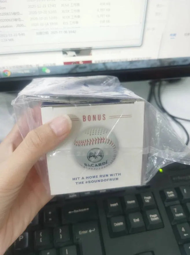 Baseball-shaped Bluetooth speaker in green colour with USB charging port