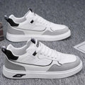 Men's low-top canvas shoes in grey with leather stitching detail on a white background