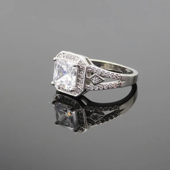 Women's platinum colour geometric zircon ring with hollow quadrilateral design on a copper band.