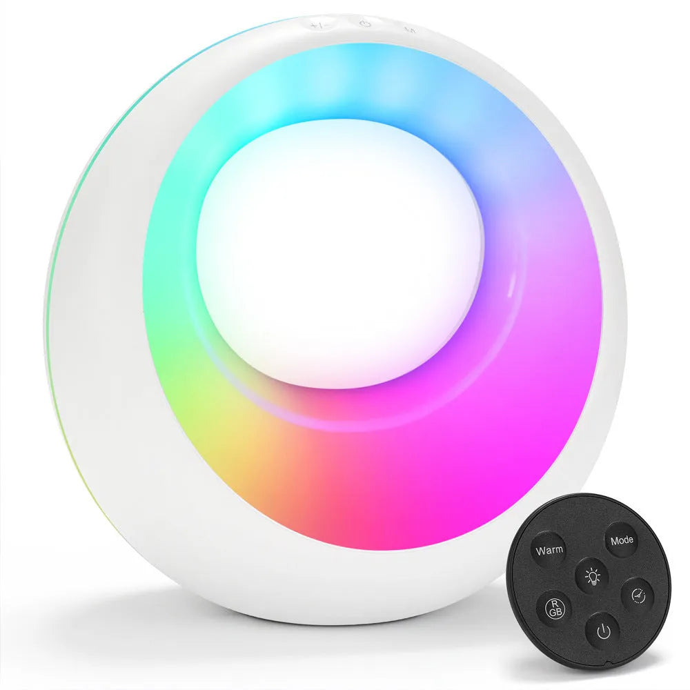 Small white desk lamp with remote control showing RGB colour-changing illumination on dark surface