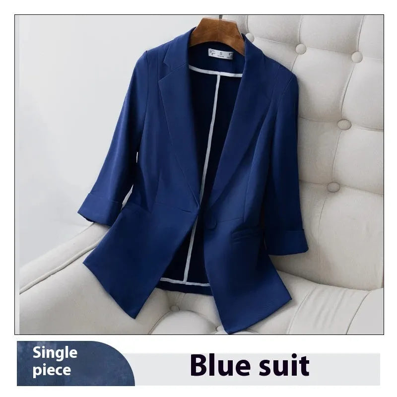 Blue polyester formal suit set with long sleeve jacket and cropped pants on a model