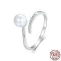 Close-up of an adjustable S925 sterling silver ring featuring a natural shell pearl on an open loop band.
