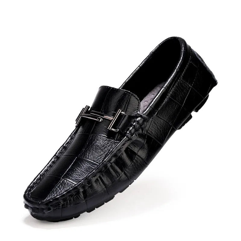 Men's leather brogue shoes in black with a belt buckle detail on a rubber sole