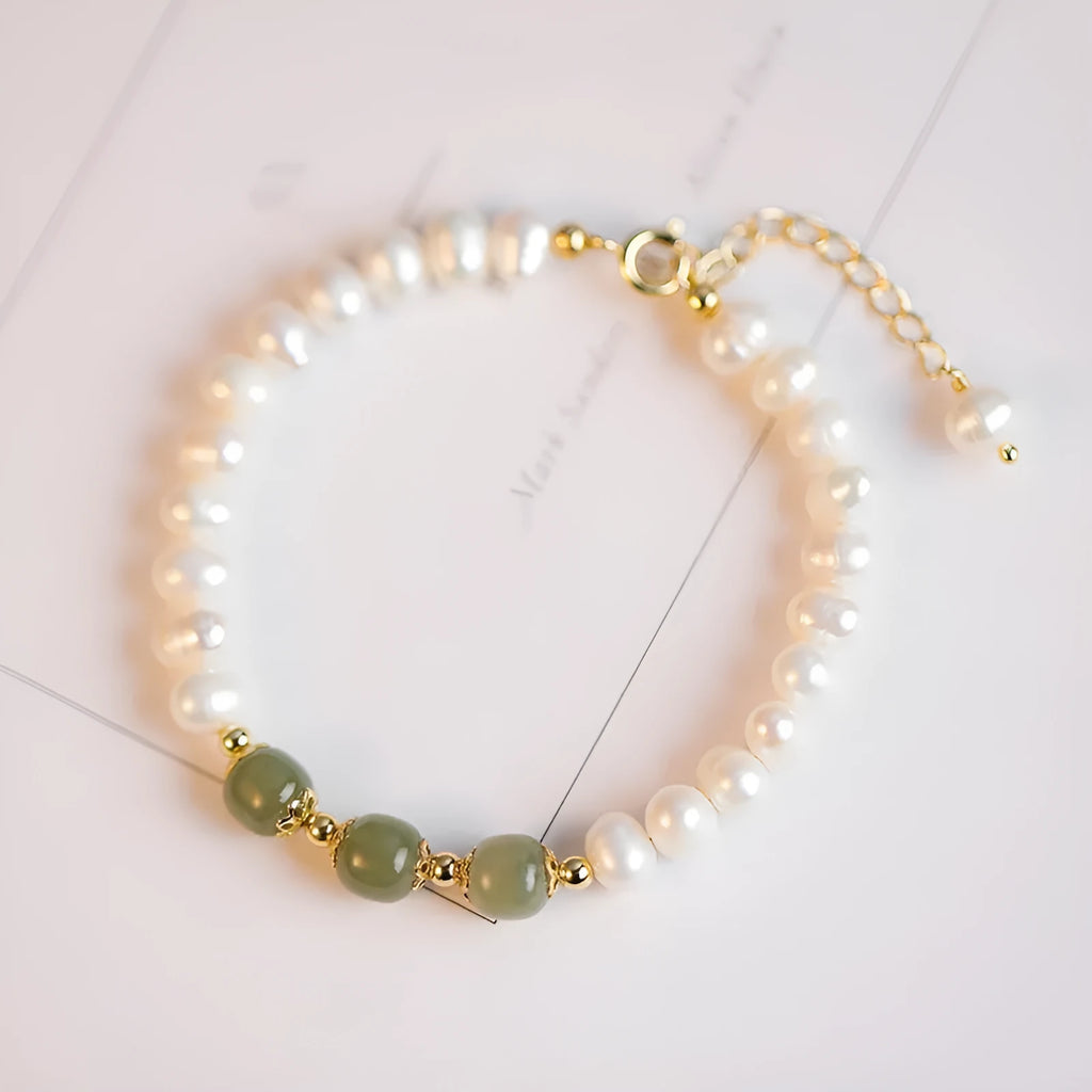 Korean style diamond-shaped freshwater pearl bracelet in Hetian jade colour on a white background.