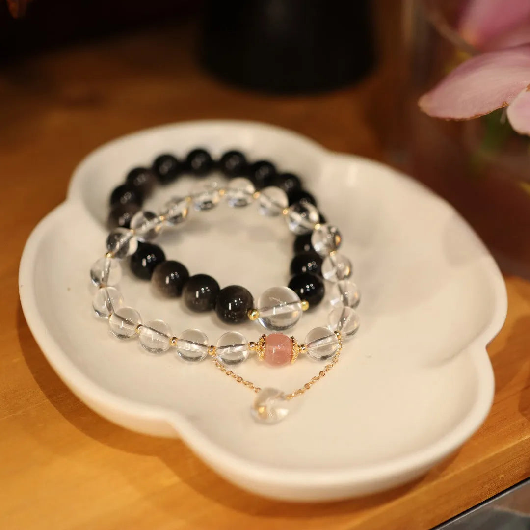 White and pink crystal bracelet with cat eye obsidian accents in Chinese geometric style