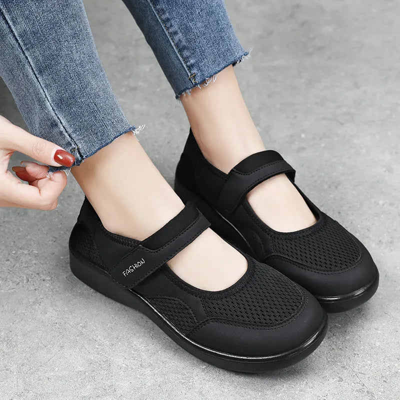 Women's low-top casual shoes in grey with mesh upper and Velcro strap.