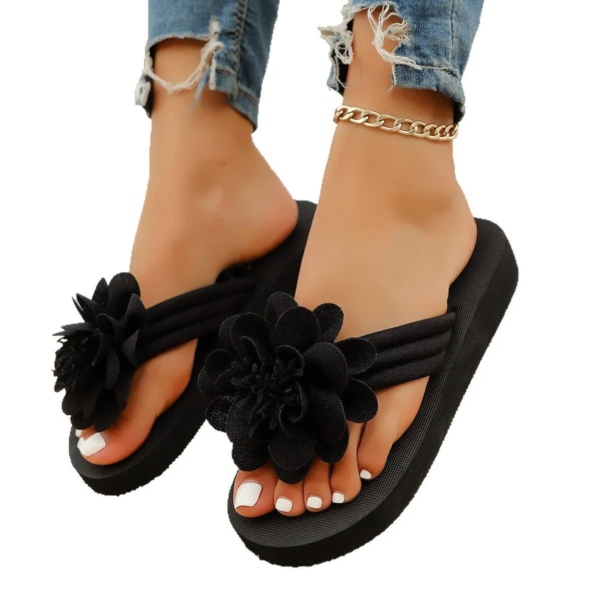 A pair of casual beige flip-flops with a floral decoration on the strap and a lightweight EVA sole.