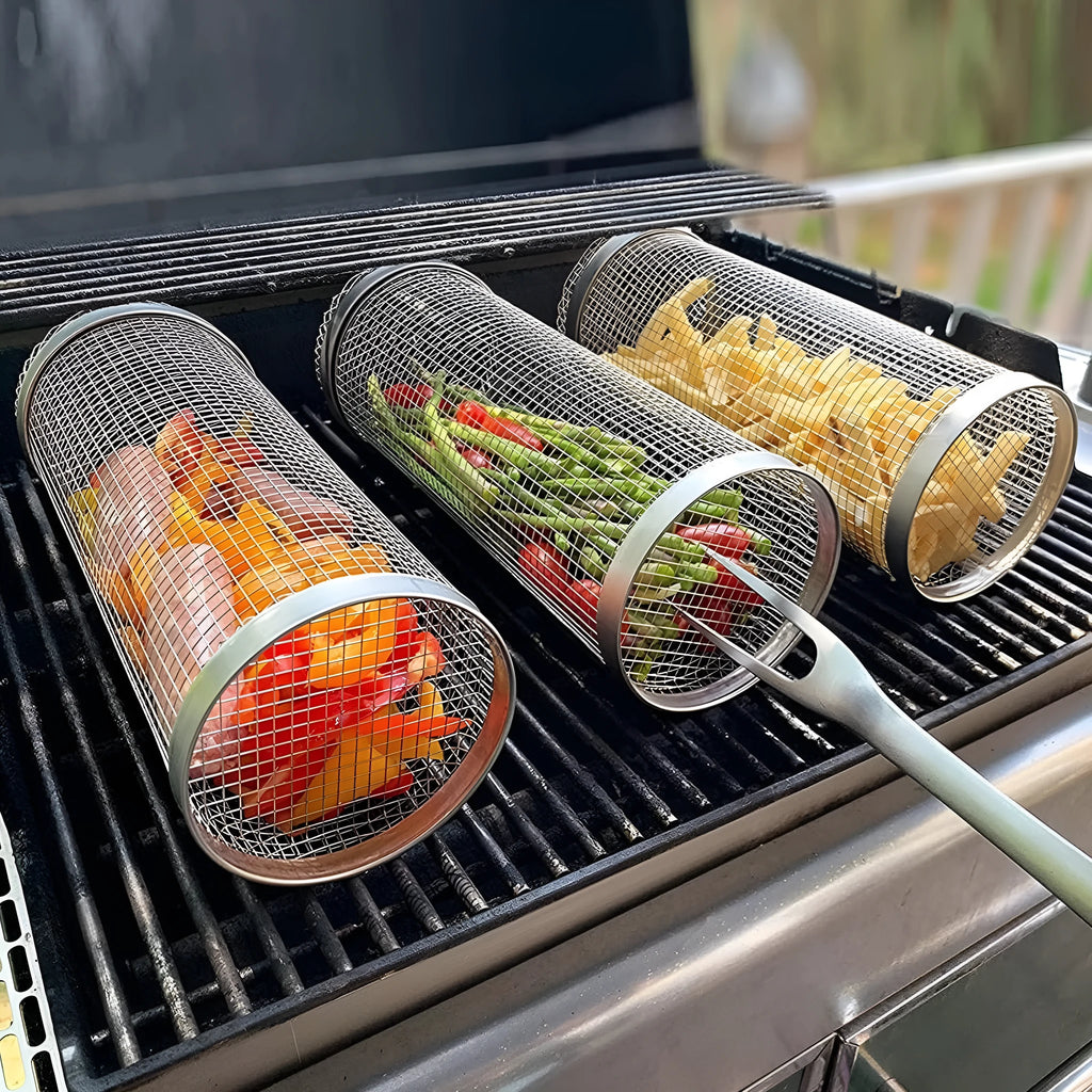 Round stainless steel rolling barbecue grilling basket with mesh sides and a hook, shown with assorted vegetables inside.