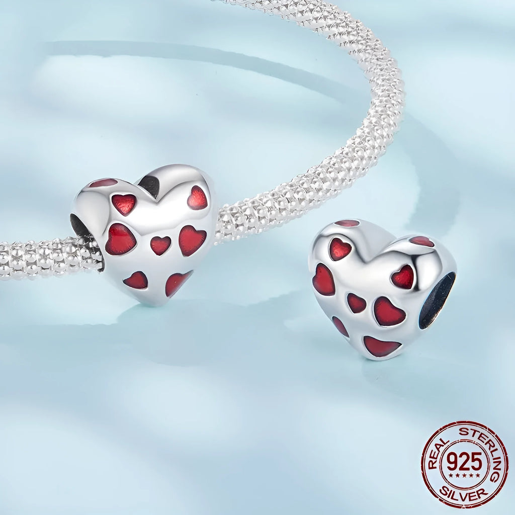 Red heart-shaped S925 sterling silver bead with glossy drip oil finish on plain background