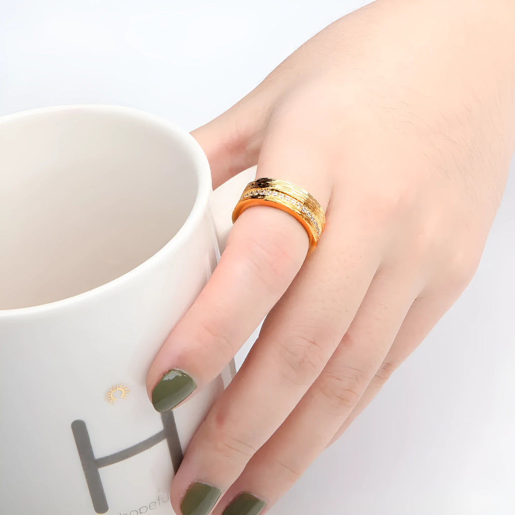 Gold geometric women's ring with zircon stone on copper base, electroplated finish.