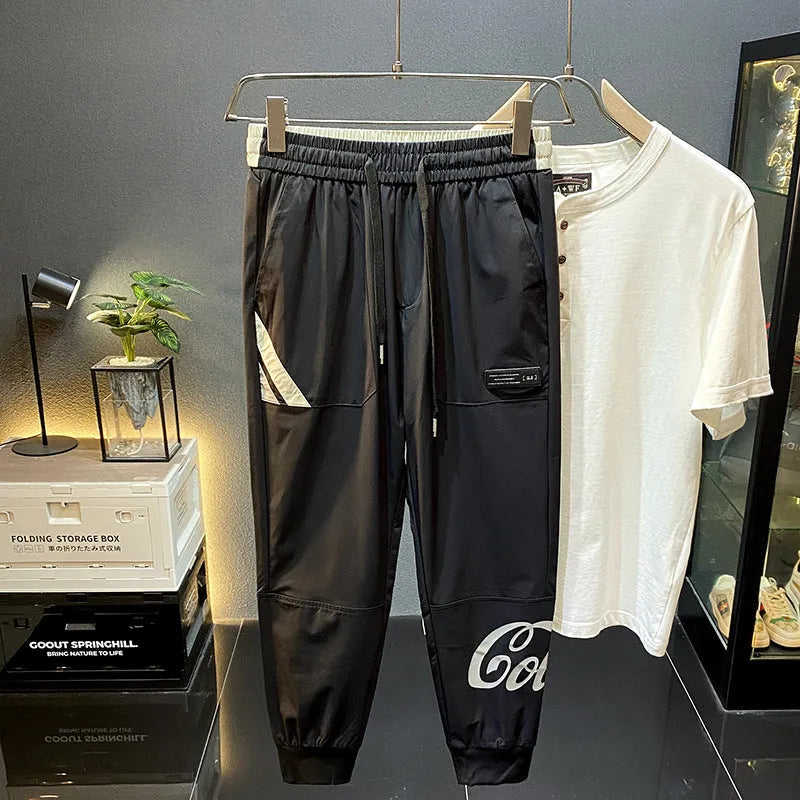 Men's black ultra-thin ice silk ankle banded cropped trousers on hanger