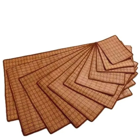 Brown rattan cooling mat for dogs on a wooden floor, showing woven texture.