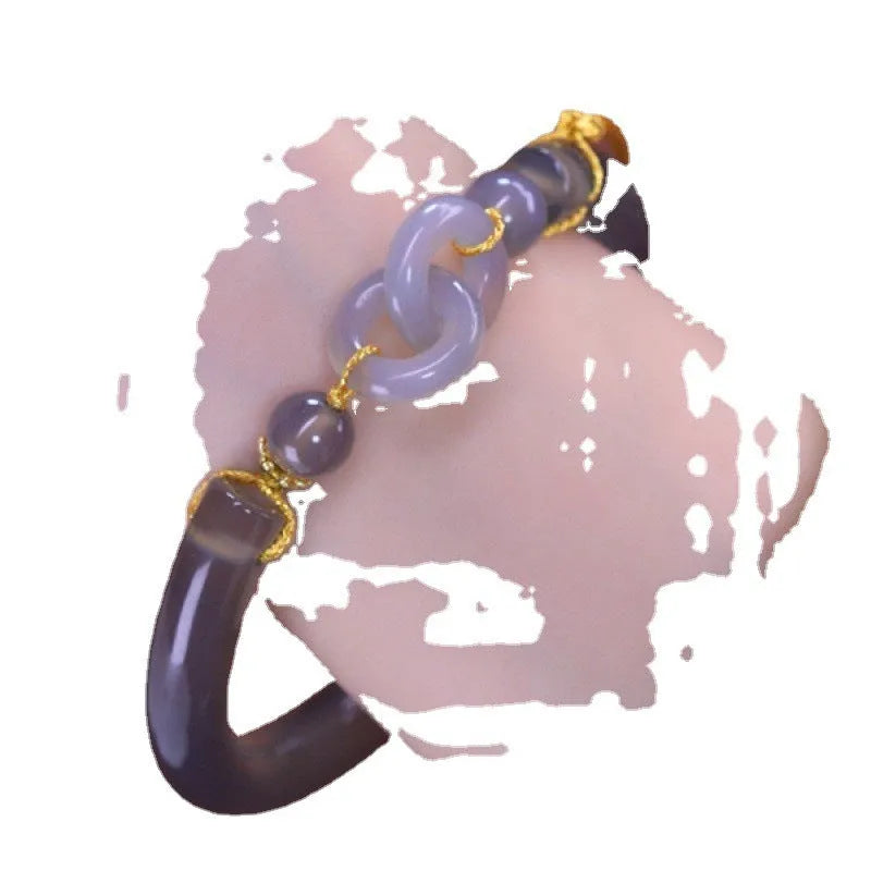 Grey smoke purple agate bead bracelet with metal ring buckle closure on a wrist.
