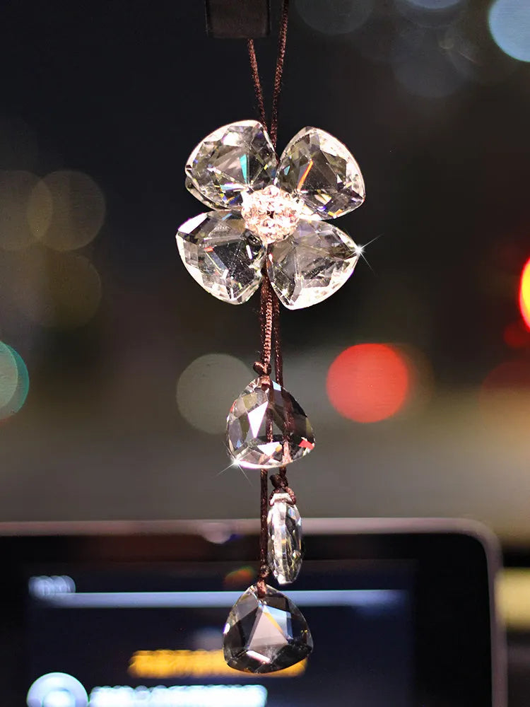 Crystal Four Leaf Grass car interior hanging pendant approximately 20cm long on a clear background.