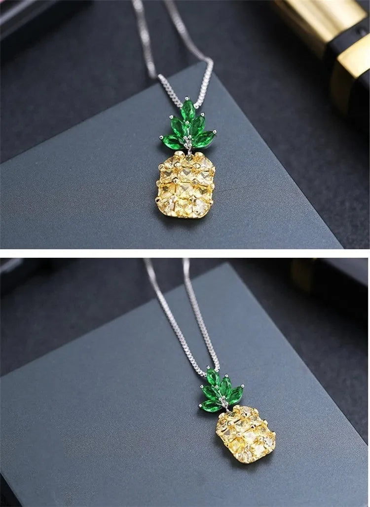 Silver coloured geometric pineapple diamond pendant necklace on a chain.