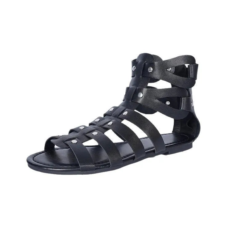 Black women's plus size flat Roman sandals with back zipper and hollow out detail on a neutral background