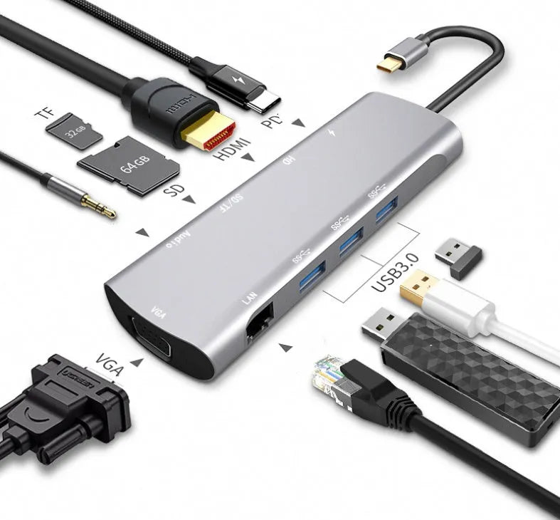 Grey aluminium USBC docking station with HDMI, VGA, USB 3.0, and charging ports on a desk.