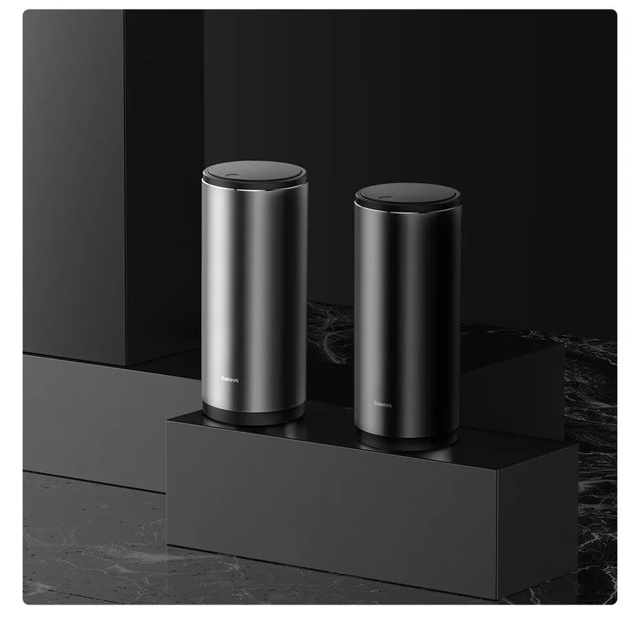 Compact aluminium alloy car trash bin with black finish, 500mL capacity, and click-open lid, placed in a vehicle cup holder
