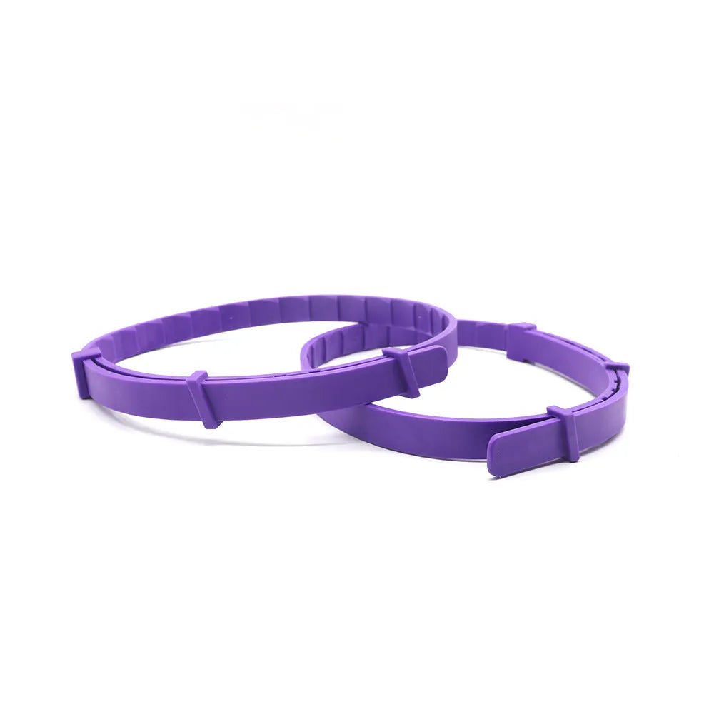 Set of four monochrome dog anxiety relief collars in different colours, showing buckle clasp and 62cm TPR band.