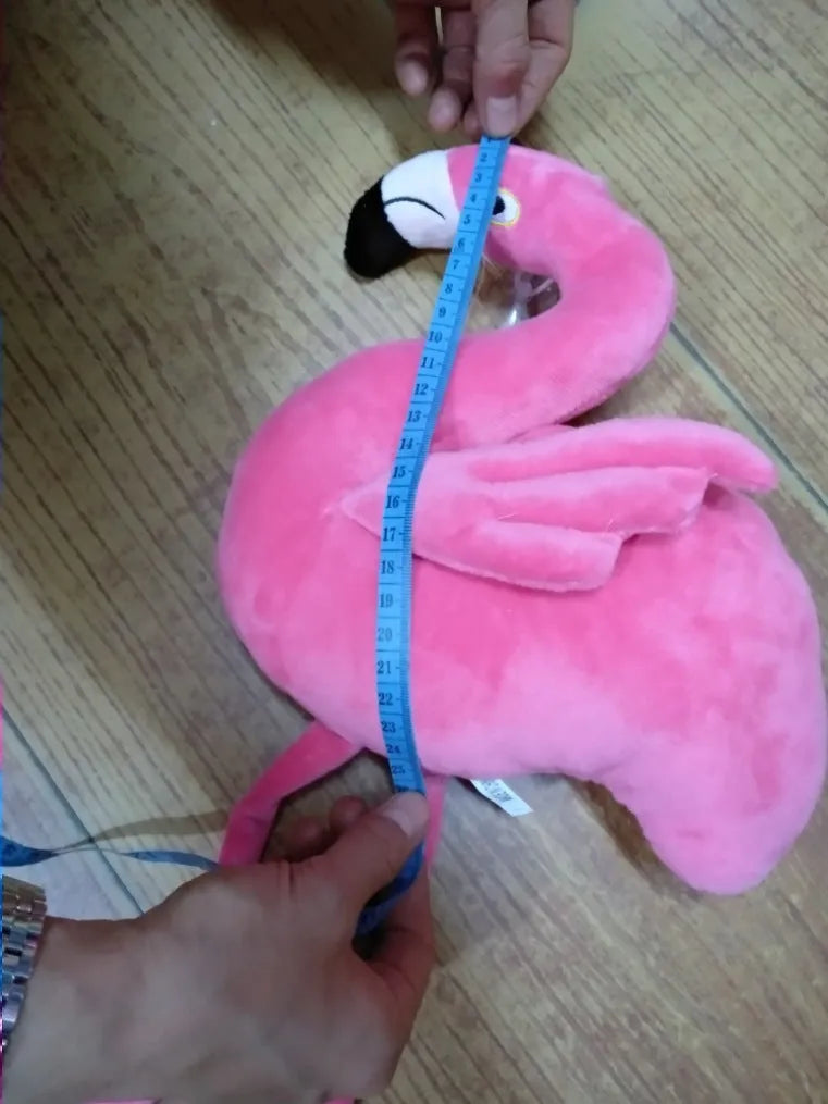 Pink flamingo plush toy with short plush fabric, filled with PP cotton, sitting on a surface