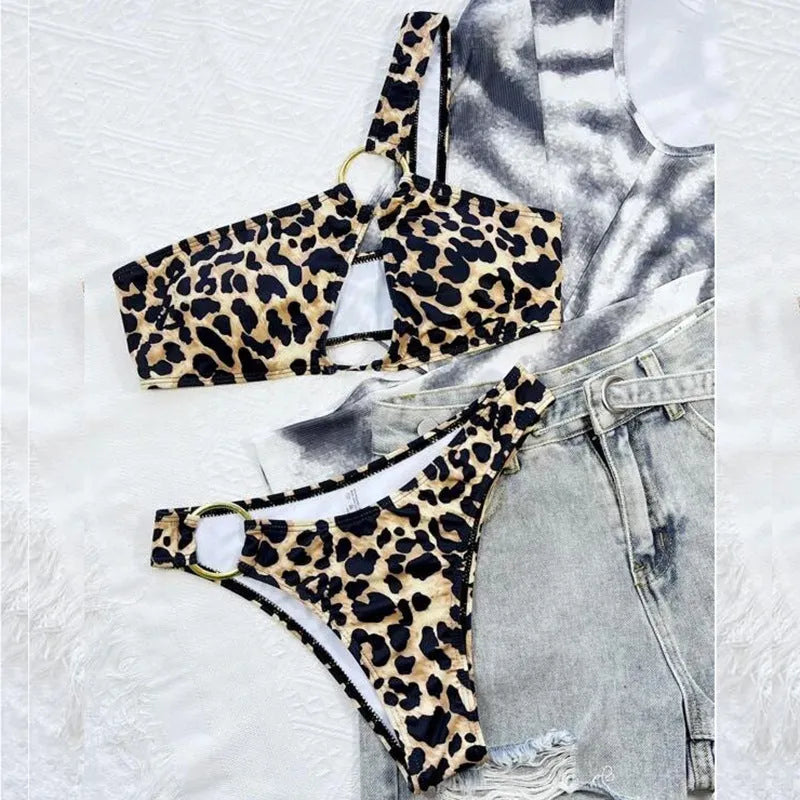 Women's hollow leopard print with polka dots bikini top and shorts set on a mannequin.