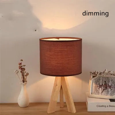 Japanese style solid wood table lamp with fabric lampshade in brown trumpet colour on bedside table