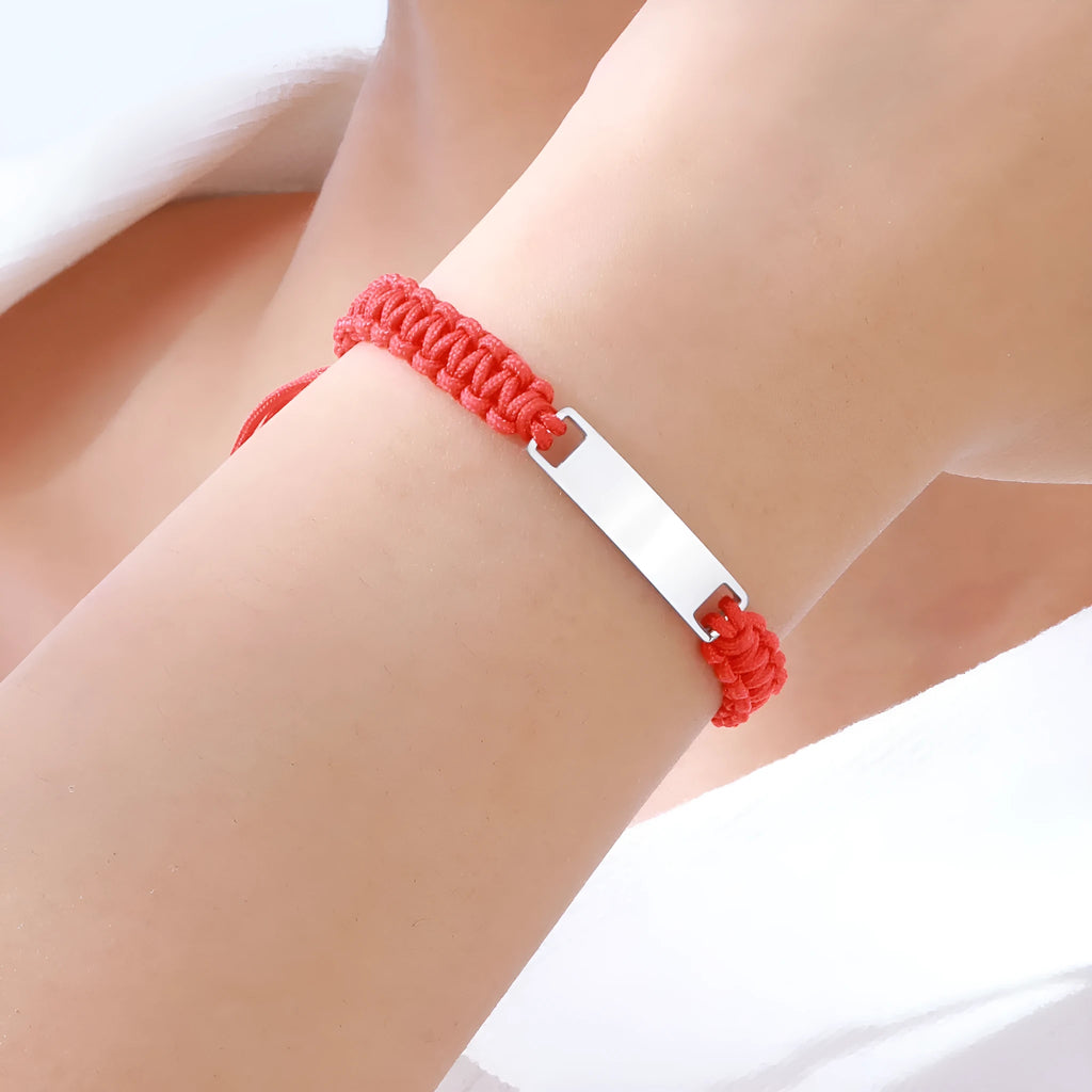 Stainless steel curved brand red nylon rope woven children's bracelet in rose gold on a white background