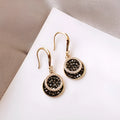 Black geometric alloy earrings with circular design measuring 3.6 cm in length