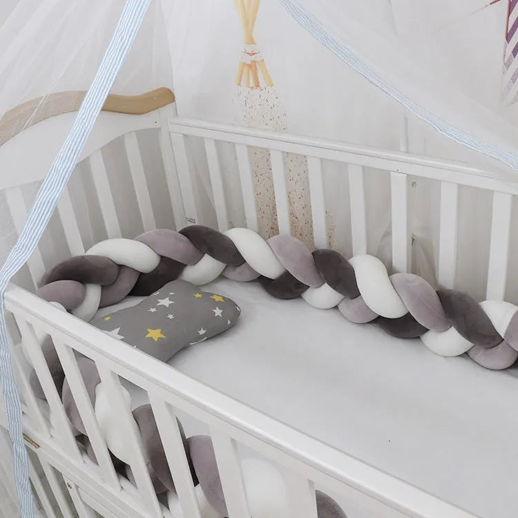 Long, flexible baby crib bumper pillow in spandex velvet, shown fitted around a white cot for safety protection.