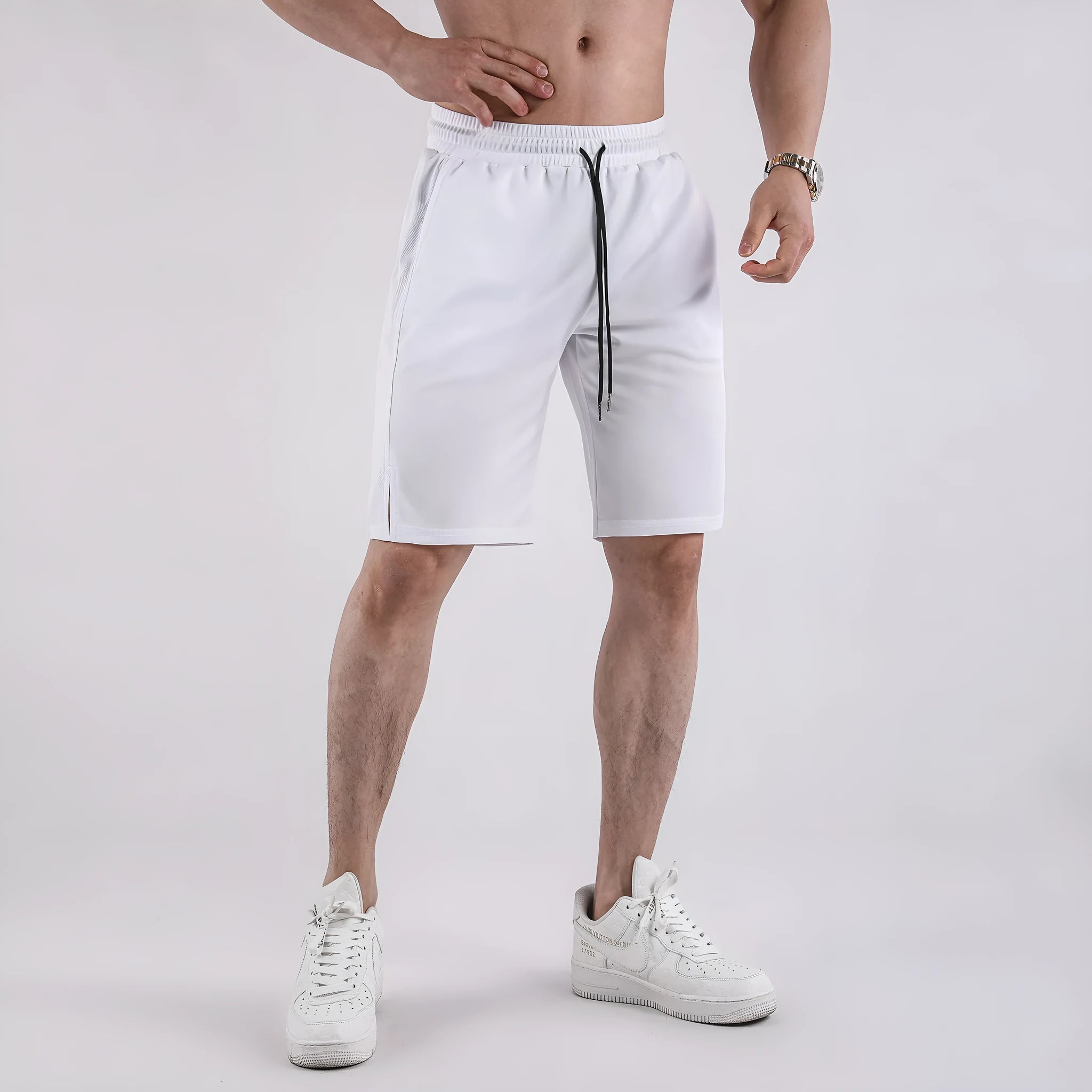 Man wearing black quick-dry mesh capri shorts with a loose, casual fit.