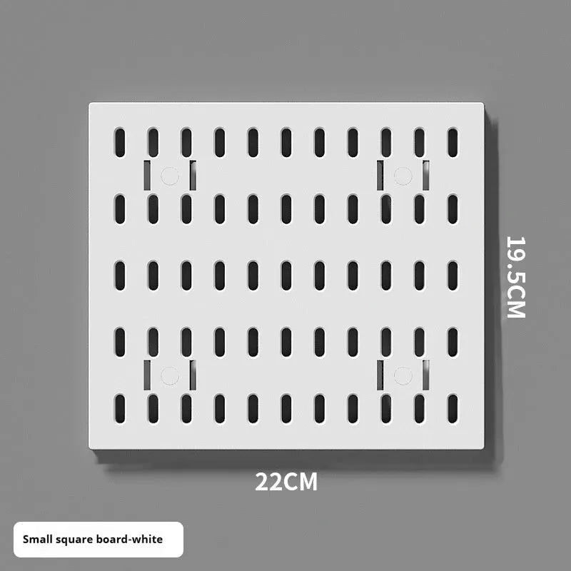 White punch-free plastic cable organisation board mounted on a wall with wires neatly wrapped.