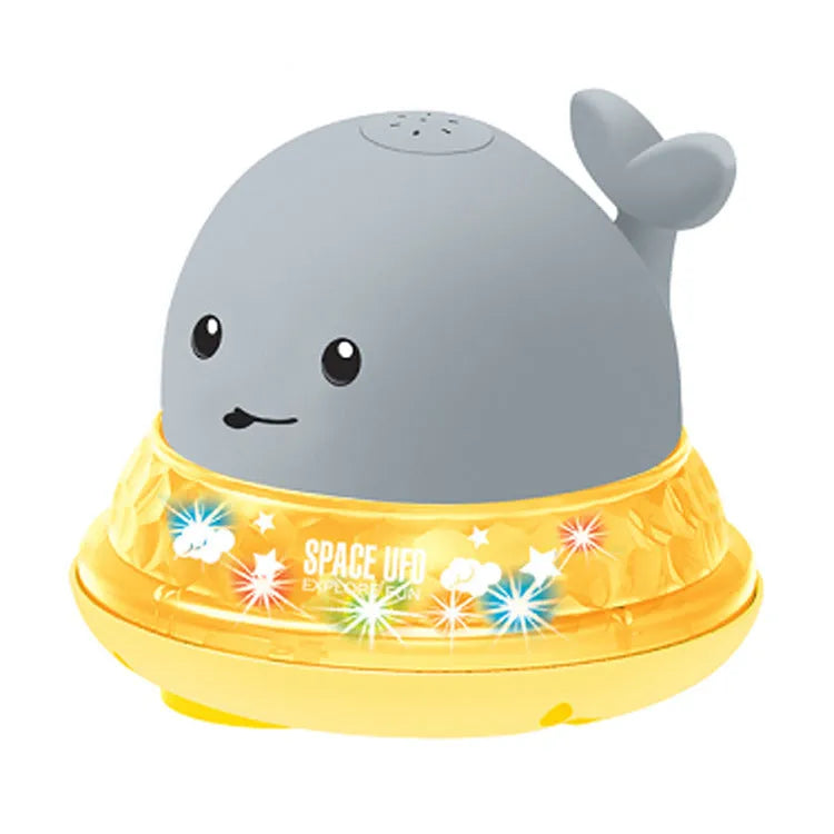 Floating grey and white whale bath toy spraying water with LED lights