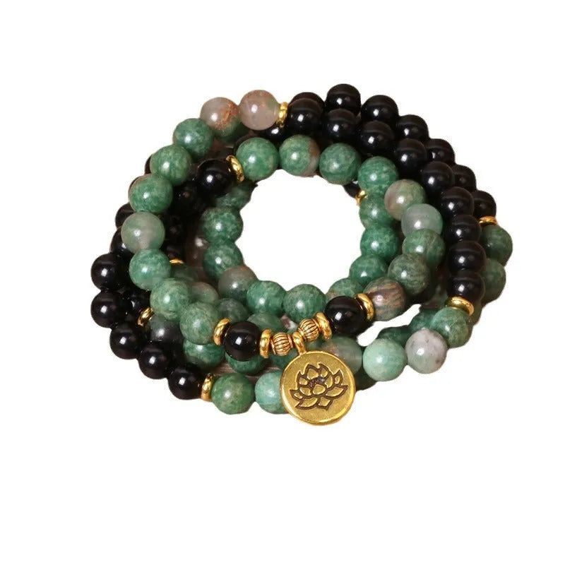Green and black alloy elastic beaded long bracelet on a wrist, showing natural style design.