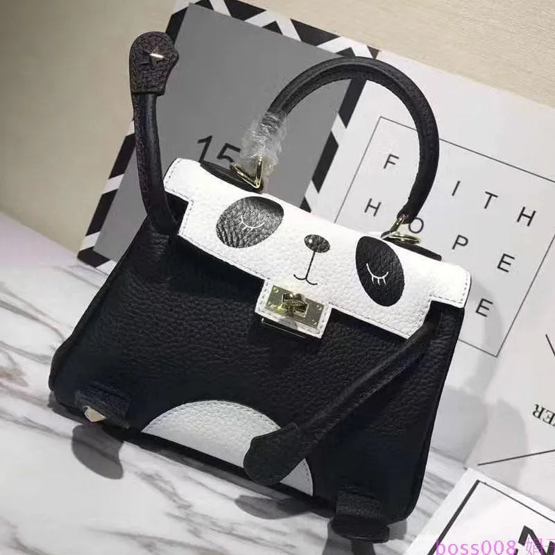 Black and white panda print square leather handbag with horizontal silhouette and structured cowhide body.