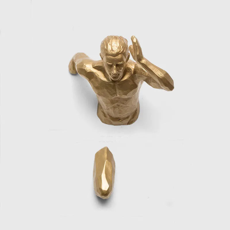 Resin character wall hanging decoration in metallic finish on a plain wall