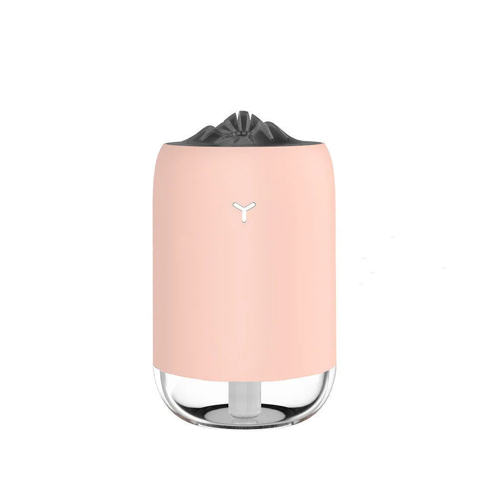 Compact cylindrical mini USB humidifier in turquoise green with a single mist outlet and night light.