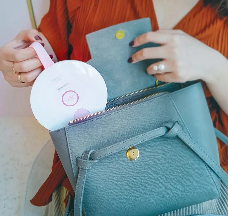 Compact blue or pink portable UV baby bottle sterilizer showing USB port and dimensions.