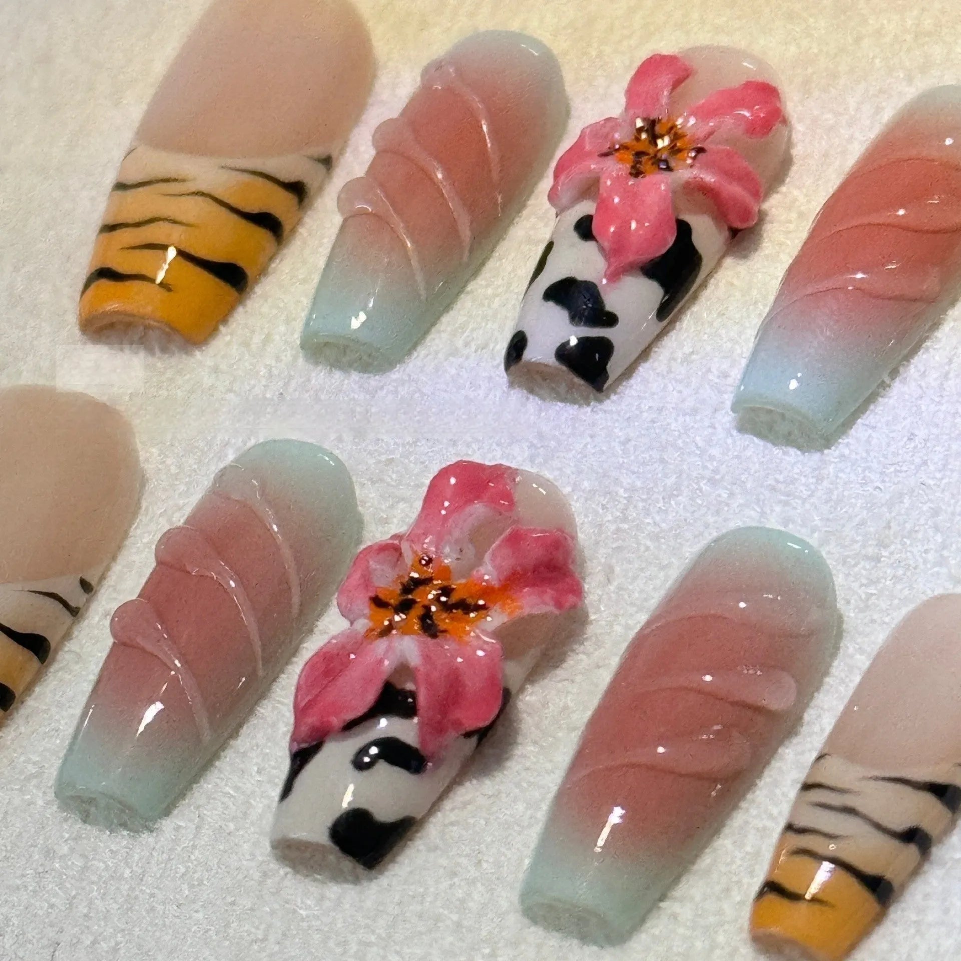 Zebra pattern lily hand carving nail art set showing embossed designs in multiple sizes