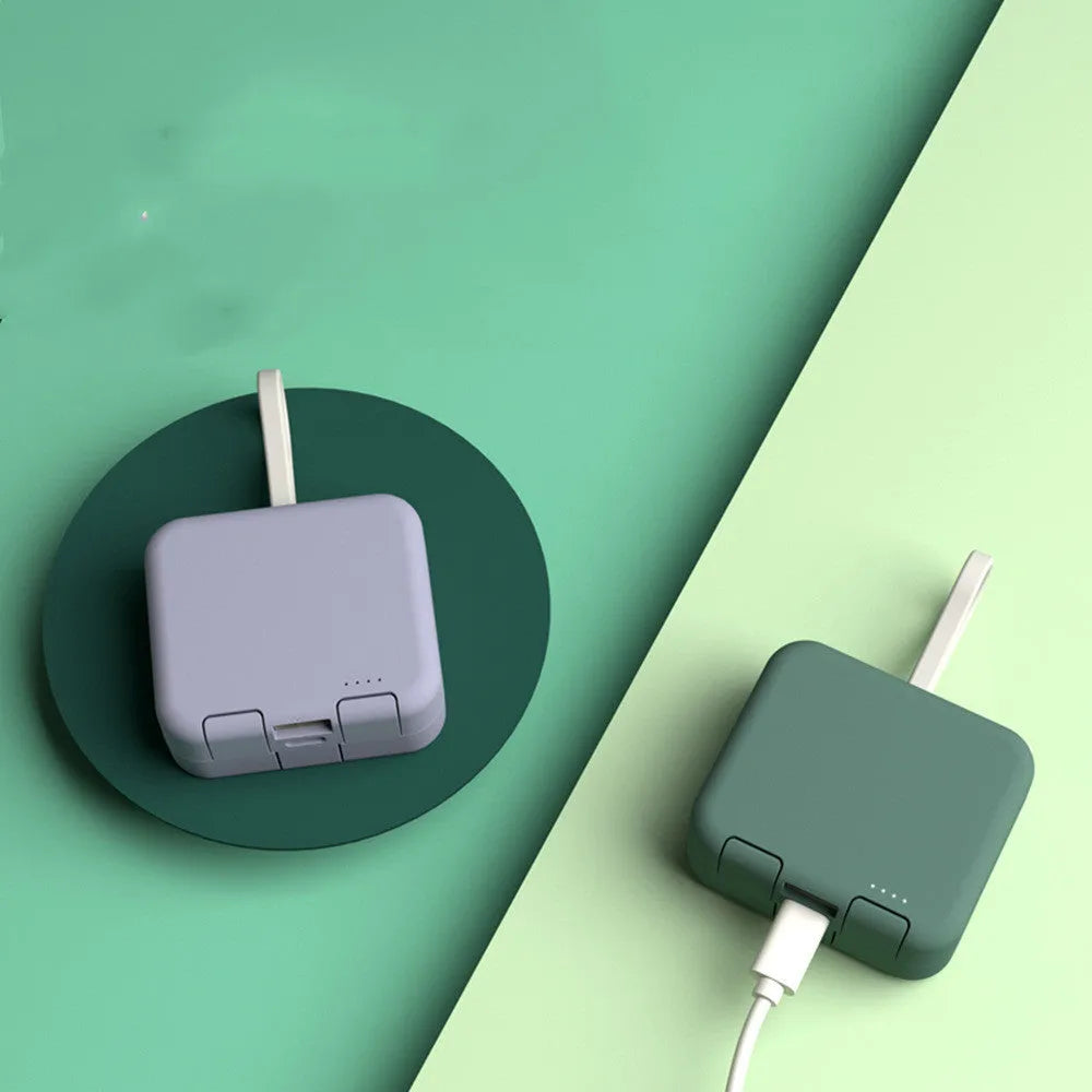 Handbag clip-on portable power bank in blue, shown charging a phone and functioning as a stand.