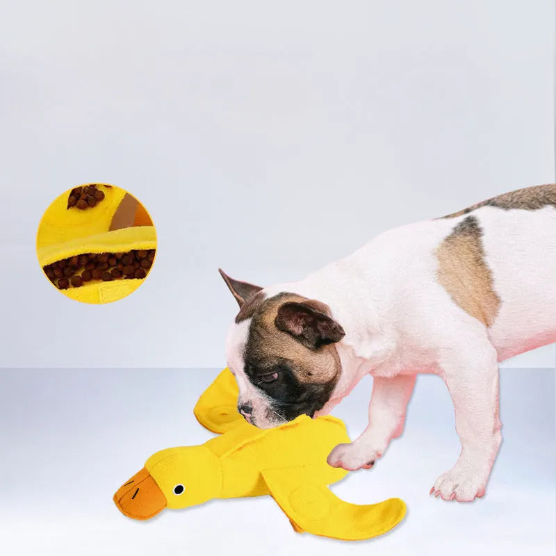 Yellow rubber duck dog toy with squeaker and treat compartment for puppy training and teething.