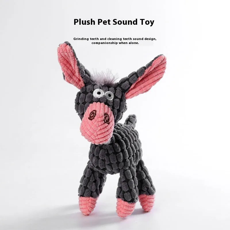 Assorted plush dog toys including a pink-gray donkey, a beige donkey, a blue elephant, and yellow ducks in three sizes.