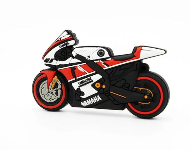 Cartoon motorcycle USB drive with red white wristband and key ring on a surface