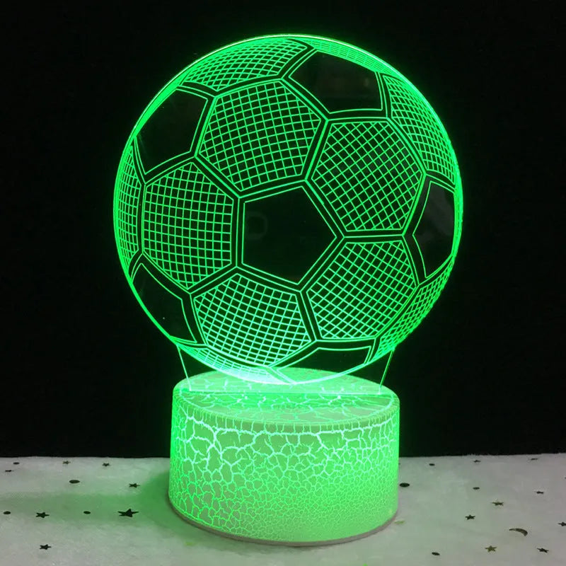 3D football-shaped LED night light on a black base showing multi-colour gradient illumination.