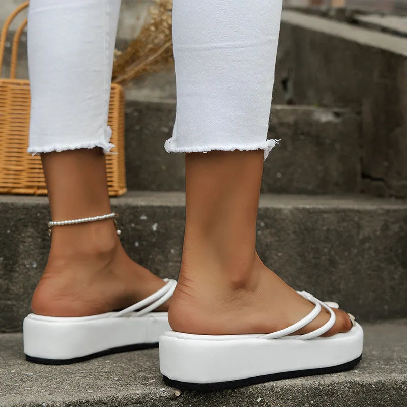 Thick-bottom herringbone-pattern flip-flops in multiple colours on a white background.
